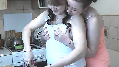 Women Day. Mature MILF and real virgin in short top T shirt without panties making cake kitchen for holiday. Girl on girl Kiss