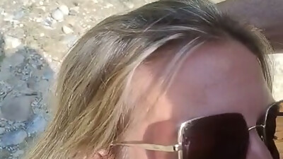 She sucks him at the water',s edge