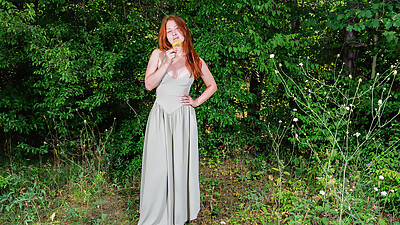 Pale redhead with perfect curves is naked in nature