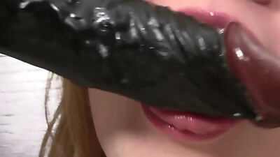 Blonde in sexy boots fucks her pussy with a huge black dildo